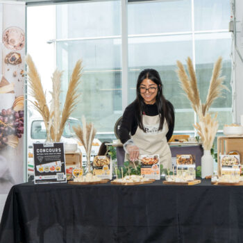 A cheese Maker with a booth at the Gold pizza Competition